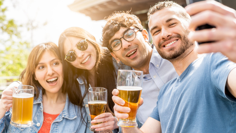 friends taking a selfie with beers