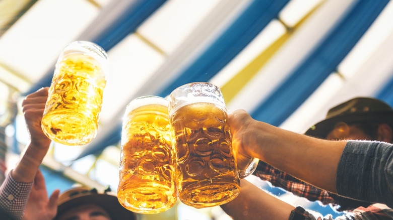 people toasting with beers