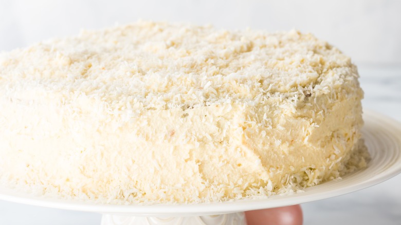 frosted cake covered in coconut