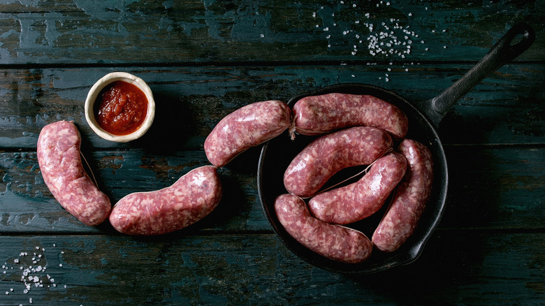 Raw sausage links in a skillet