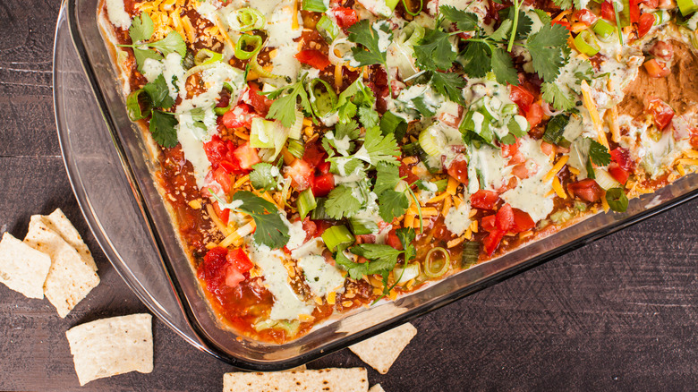 bird's eye view of layered dip in a glass casserole tray
