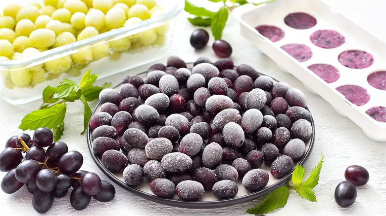 Frozen purple grapes on plate