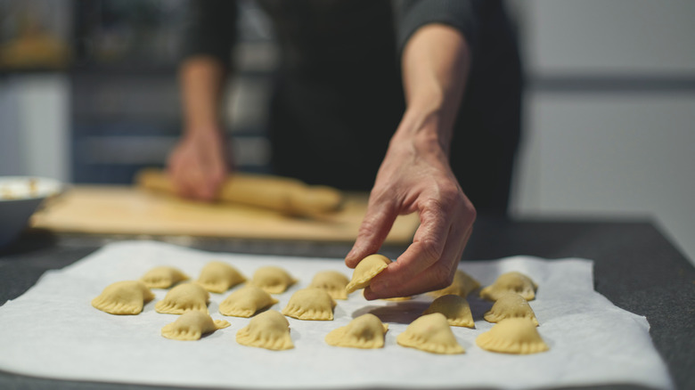 hand reaching out to handmade pasta