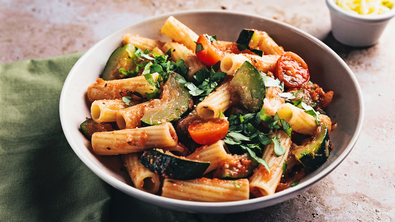 High angle view of rigatoni with zucchini and tomato sauce