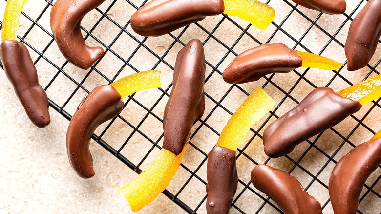 Candied chocolate covered orange peels on wire rack