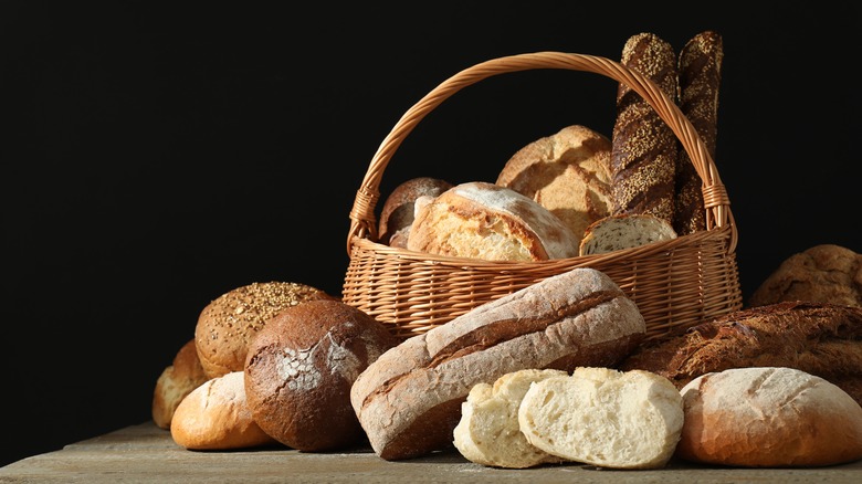 Wicker basket full of different types of bread loaves