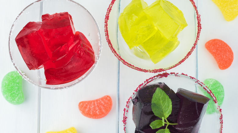 alcoholic gelatin mixes in cocktail glasses with candy garnish