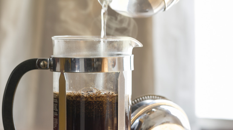 pouring water into French press coffee maker