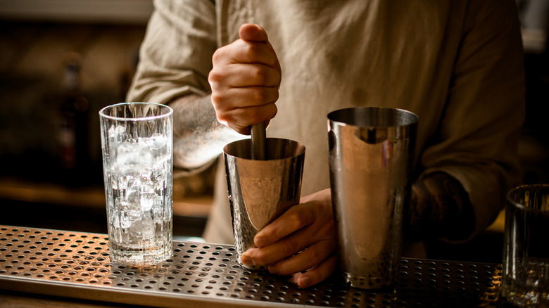 bartender muddling cocktail
