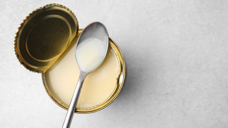 Can of condensed milk with spoon