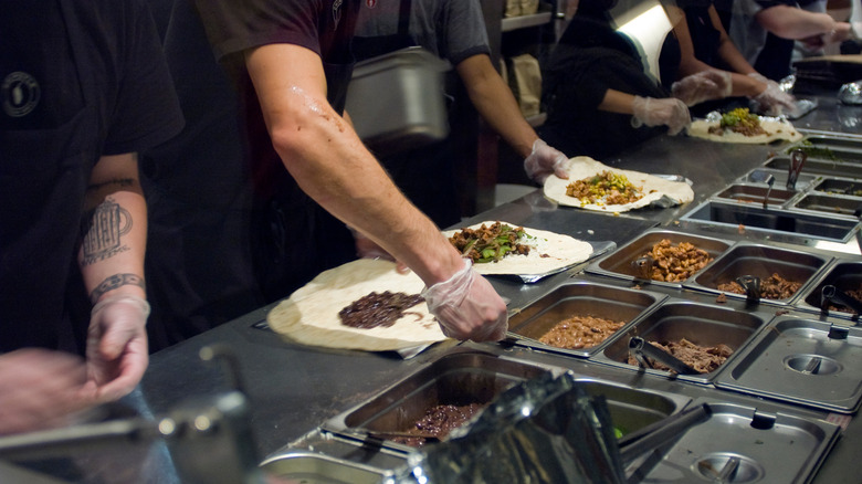 chipotle workers assembling burrito
