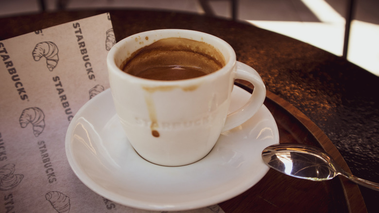 Starbucks ceramic mug with hot chocolate sits in a saucer