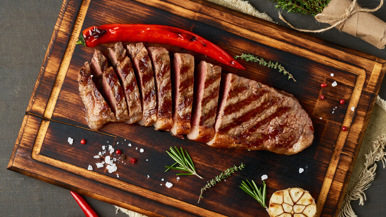 sliced steak on cutting board