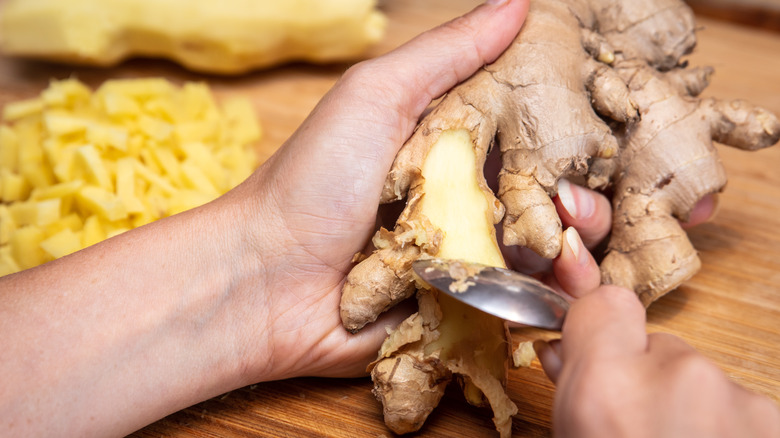 peeling ginger root with spoon