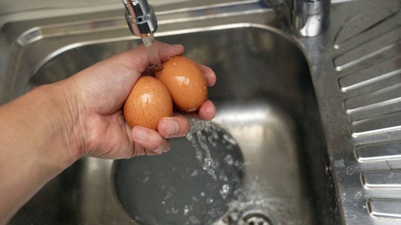 Running eggs under sink faucet