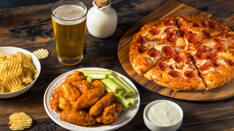 Pizza, chips, wings, and pint of beer