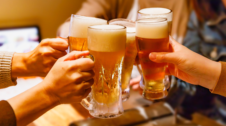 Friends toasting their glasses of beer together