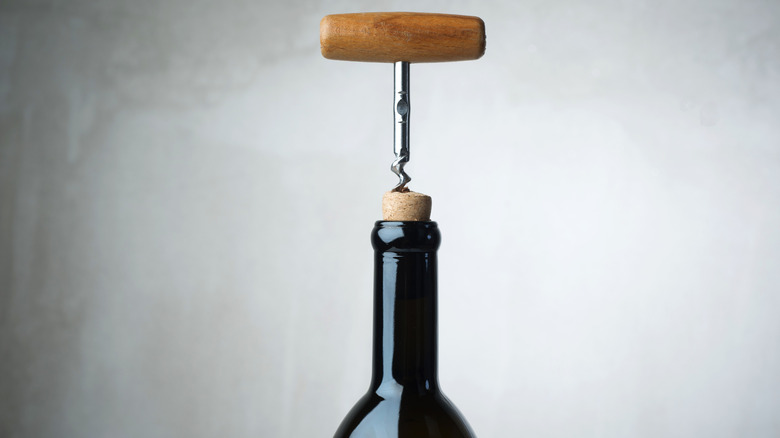 wine opener in cork of wine bottle