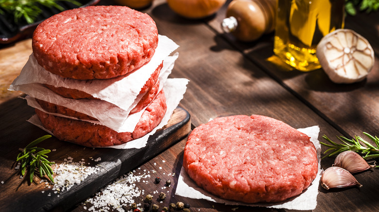 raw beef patties on counter