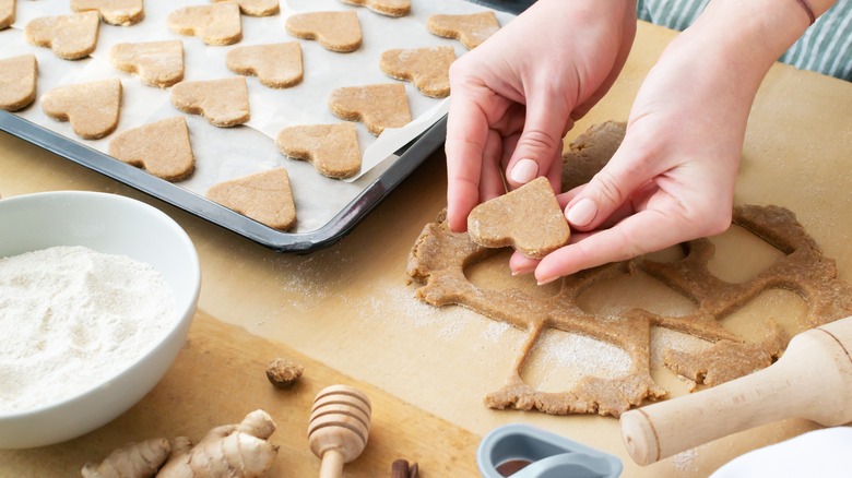 woman making heart sugar cookies