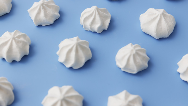 Puffs of white meringue on a blue background