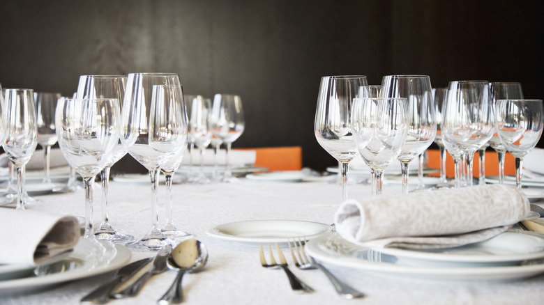 Table set with multiple different kinds of glassware, including red and white wine glasses