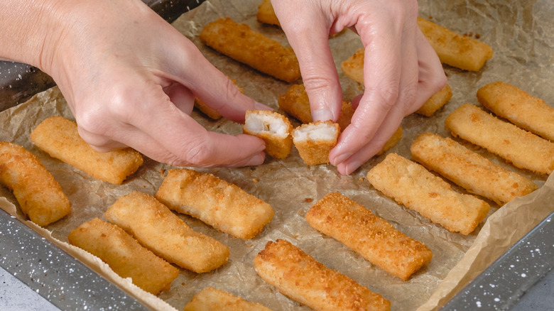 Fried fish sticks on a baking sheet