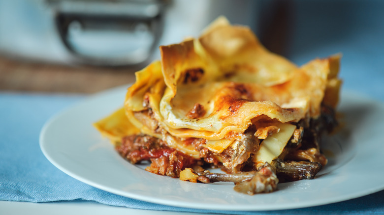 a portion of overheated lasagna on a white plate