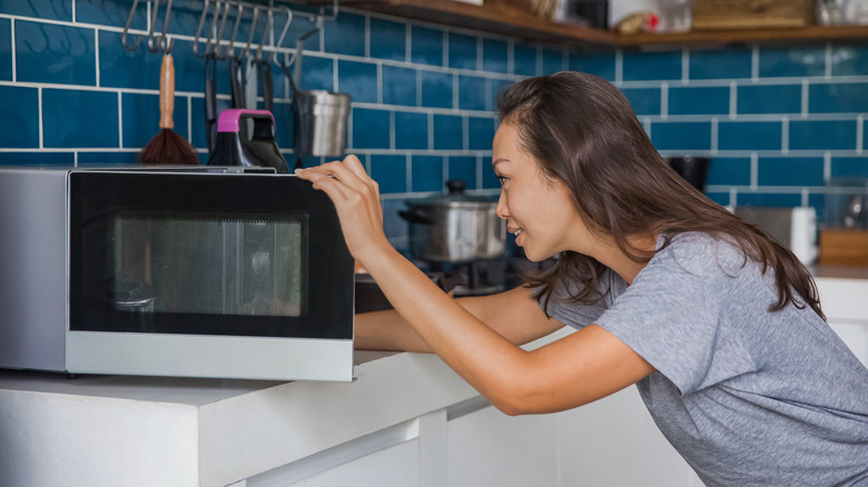 woman using the microwave