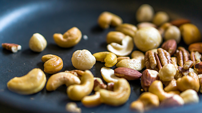 Closeup of mixed nuts in a frying pan