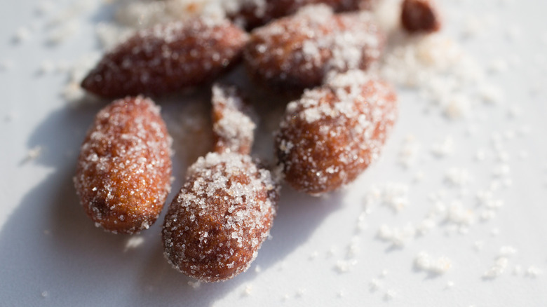 Closeup of roasted almonds sprinkled with coarse salt