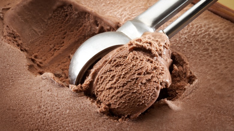 Chocolate ice cream being scooped  