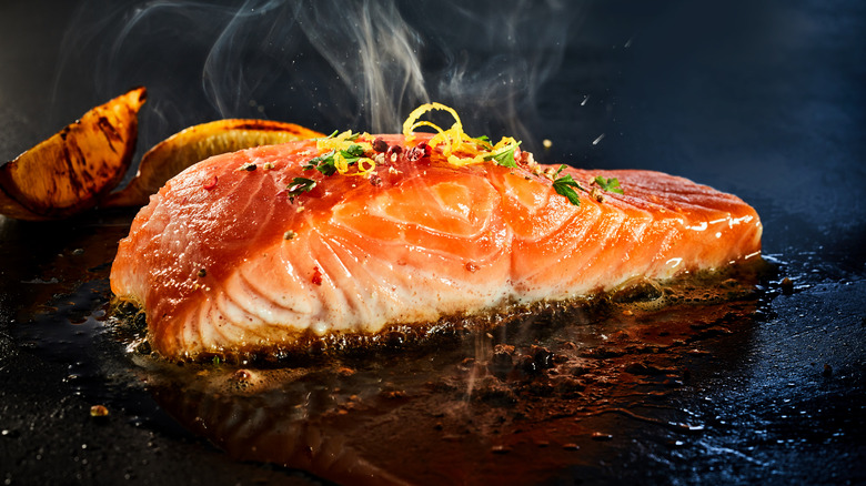Piece of salmon on a hot griddle