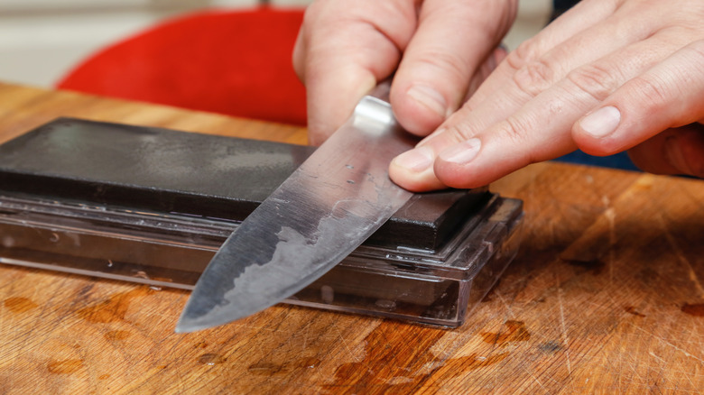 Sharpening a knife on a whetstone