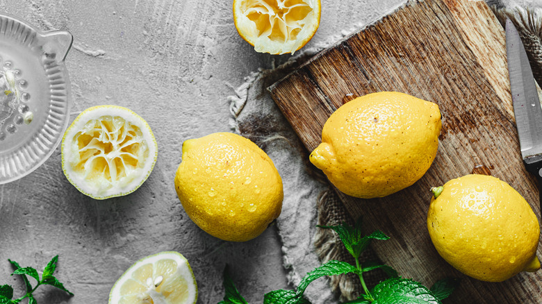 lemons being juiced on cutting board