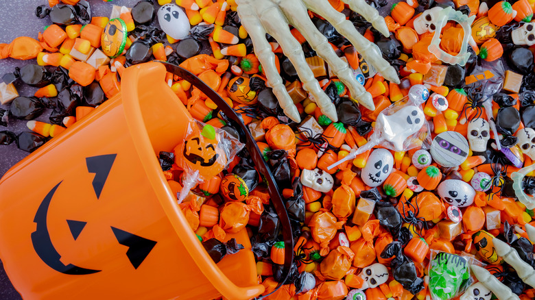 orange Halloween pail spilled over with candy