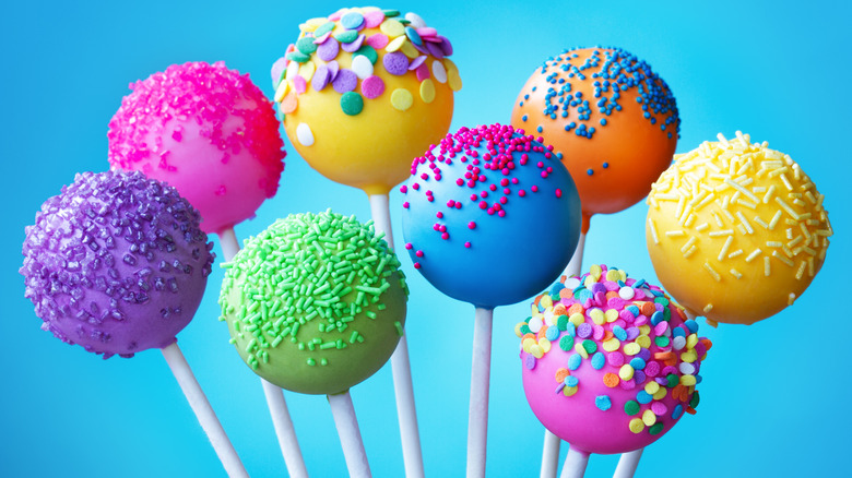 A bunch of colorful cake pops