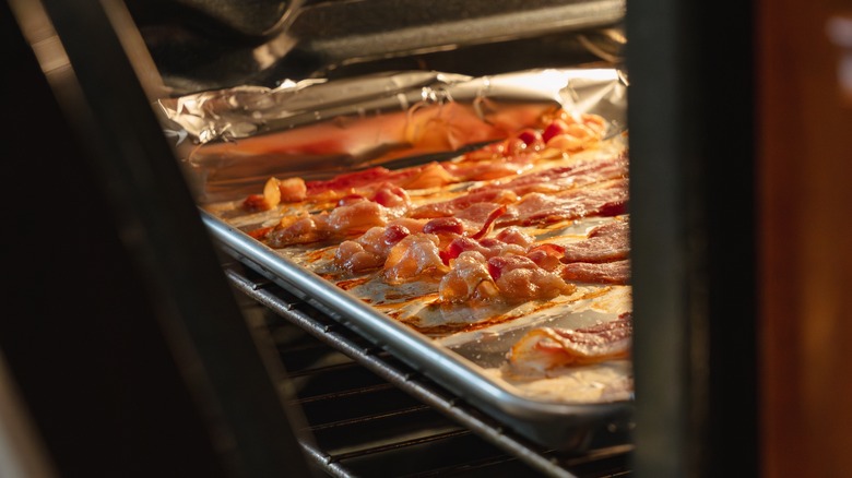 bacon reheating on a baking tray inside an oven