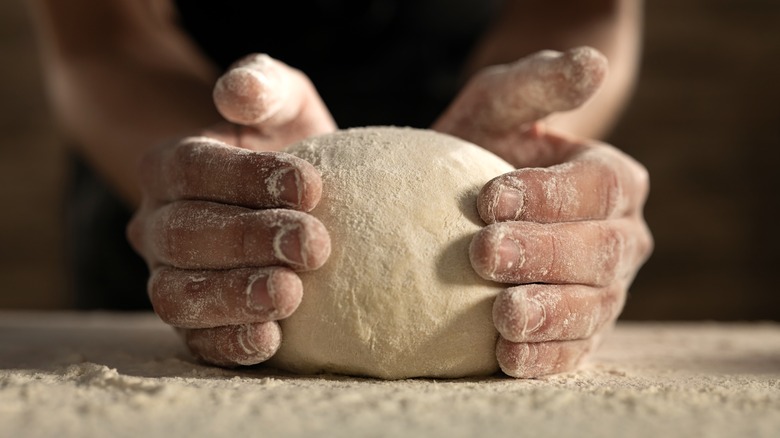 hands shaping fresh pasta dough