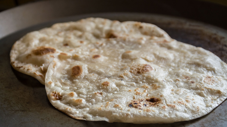 Flour tortillas cooking on comal