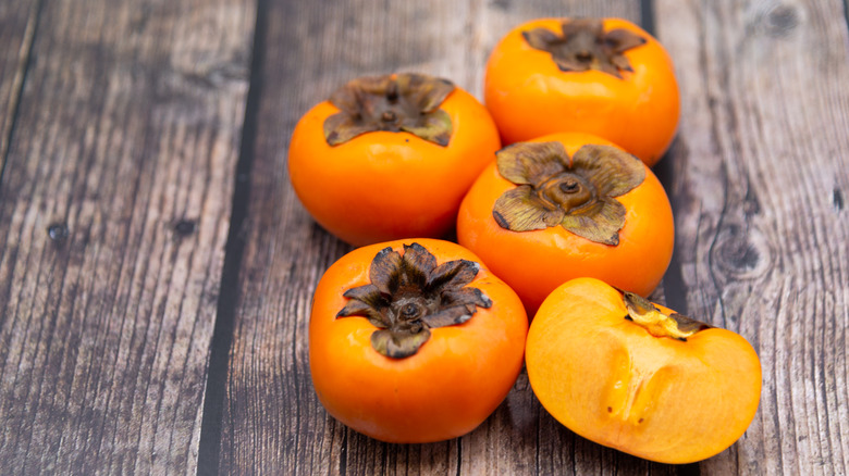 Persimmons on a wooden board