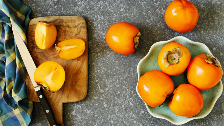 Whole and halved persimmons