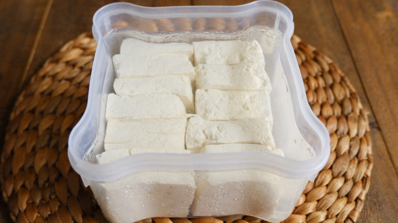 Cubes of tofu in a container with water