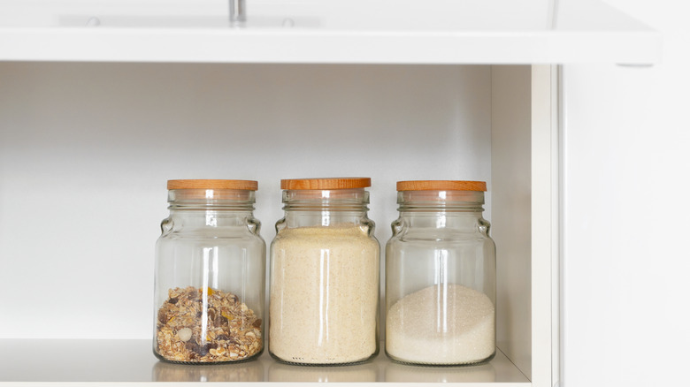 White sugar in glass container in cabinet