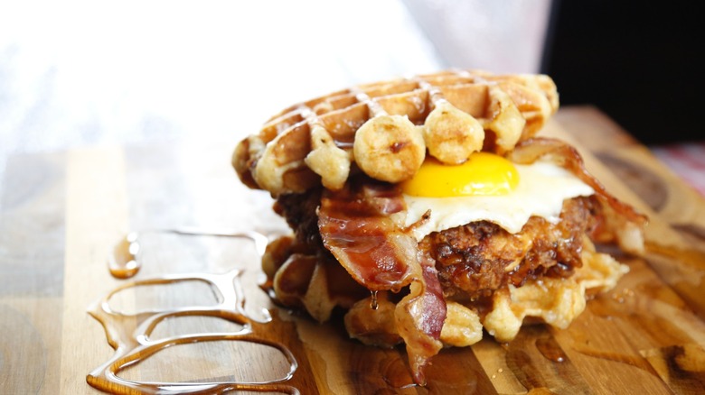 Chicken and waffles sandwich with egg and bacon