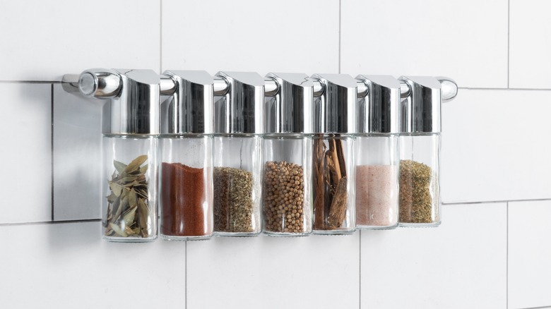 a modern spice rack made of metal and glass.