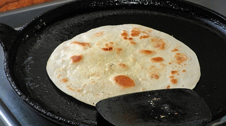 Heating a tortilla in a pan