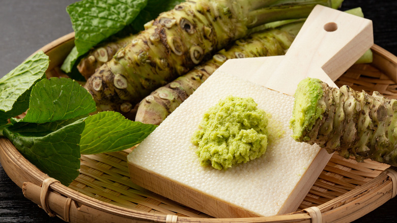 Wasabi roots in a basket with wasabi paste