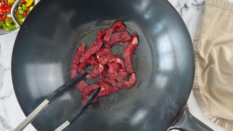 beef strips in wok