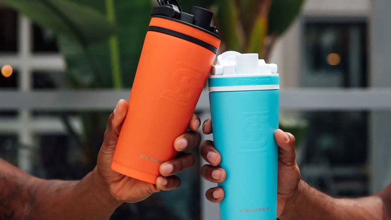 Two hands holding Ice Shaker bottles